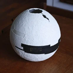White Cement Sphere with Black Geometric Insertions